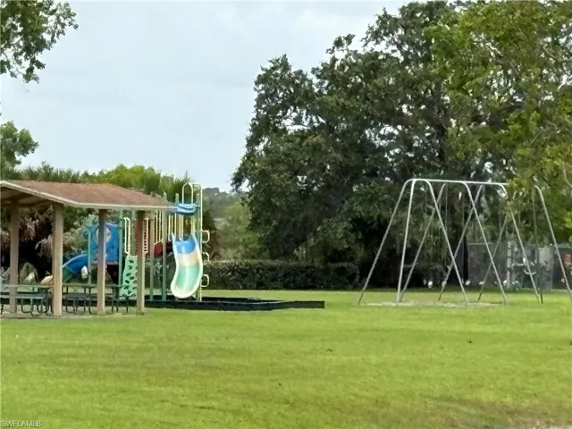 Community jungle gym featuring a lawn