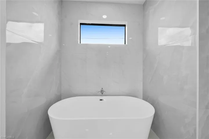 Bathroom with tile walls and a bathing tub