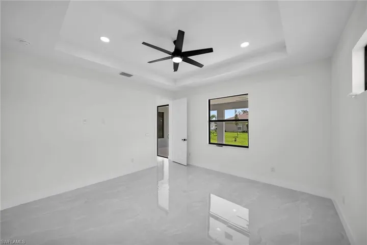 Spare room featuring ceiling fan and a raised ceiling