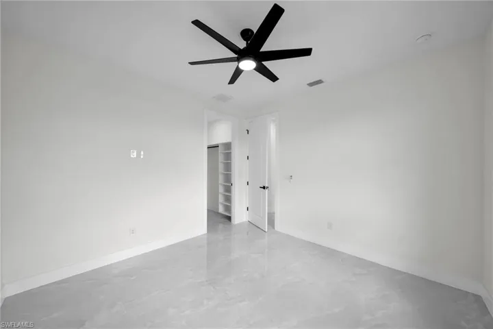 Spare room with ceiling fan