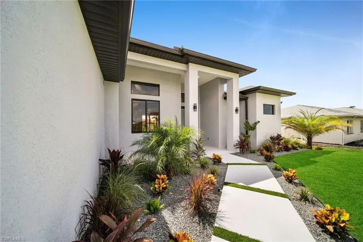 View of exterior entry featuring a yard