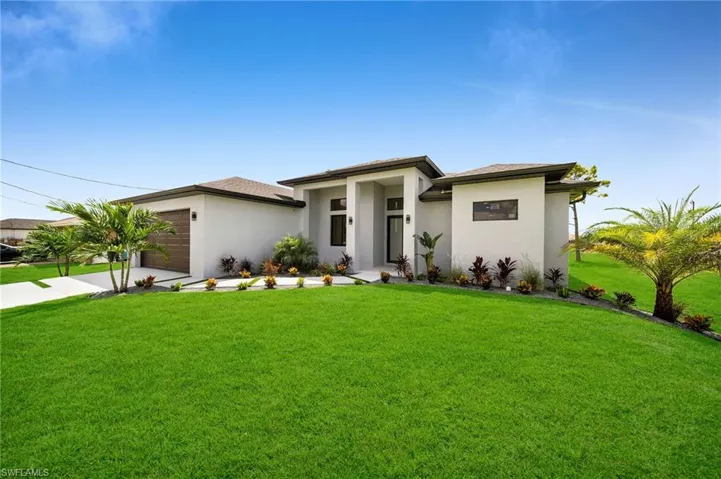 Prairie-style home with a front yard and a garage