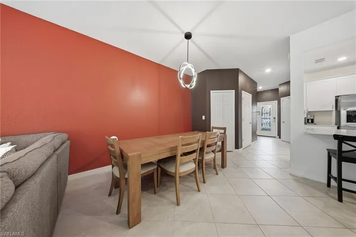 Dining room featuring light tile patterned floors and recessed lighting