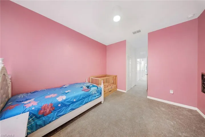 Carpeted bedroom with baseboards