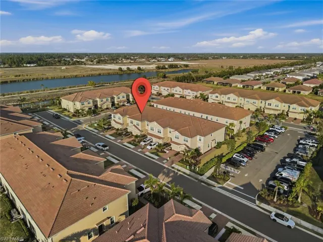 View of property location with a large body of water and nearby suburban area