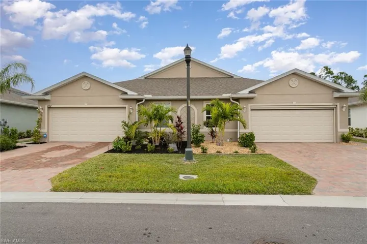 Single story home featuring a garage and a front yard