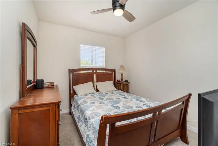 Bedroom featuring ceiling fan and light carpet