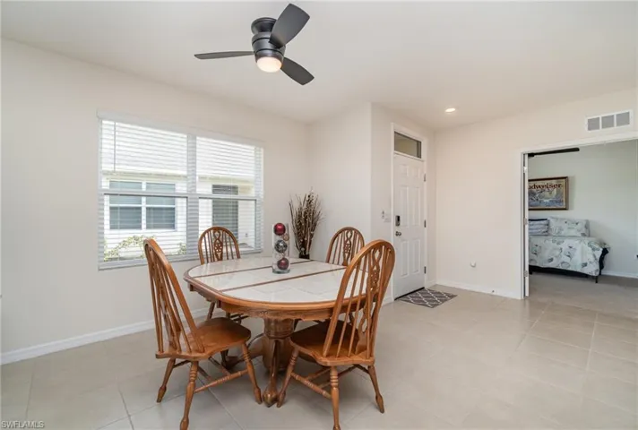 Tiled dining space with ceiling fan