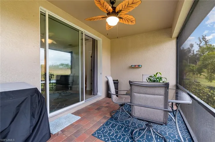 Balcony featuring area for grilling and ceiling fan