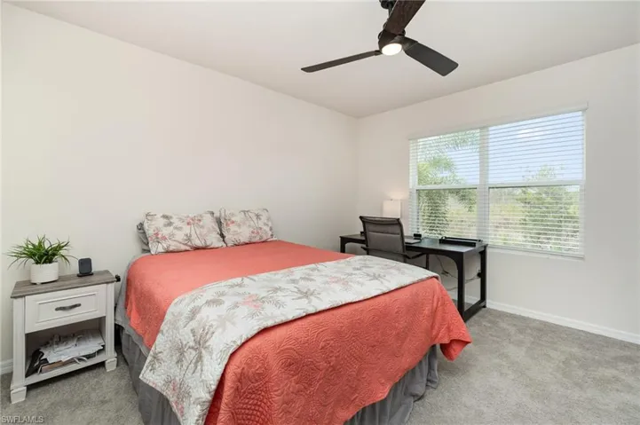 Bedroom featuring ceiling fan and carpet floors