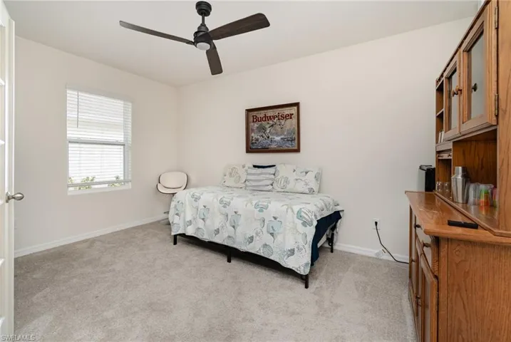 Bedroom featuring ceiling fan and light colored carpet