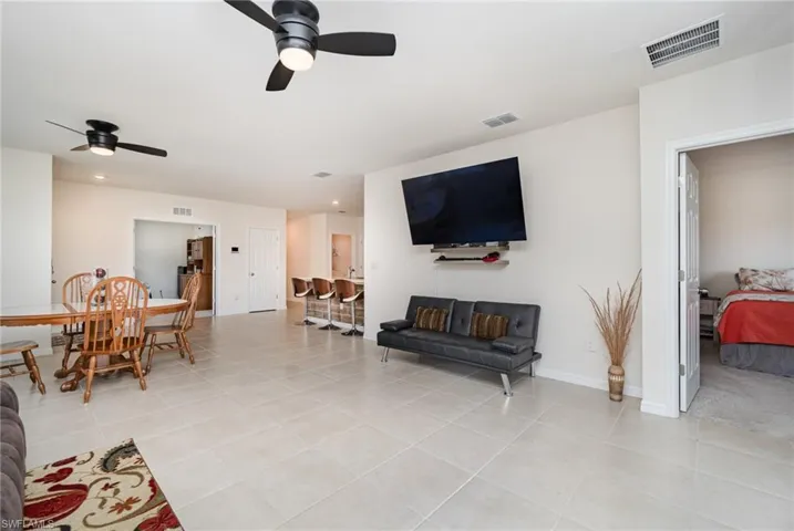 Tiled living room featuring ceiling fan