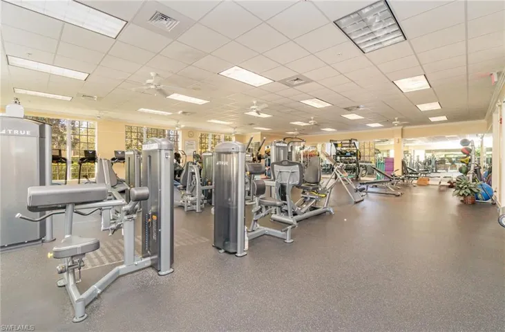 Workout area with a paneled ceiling and ceiling fan