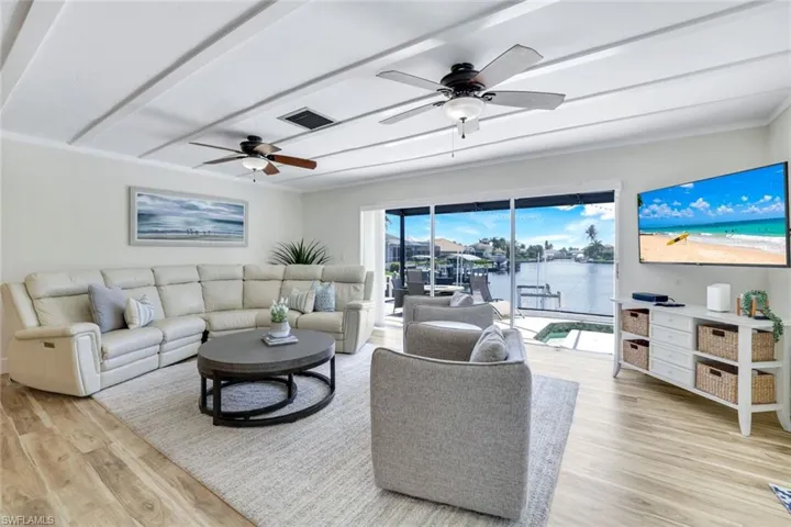 Living room with light wood-type flooring and ceiling fan