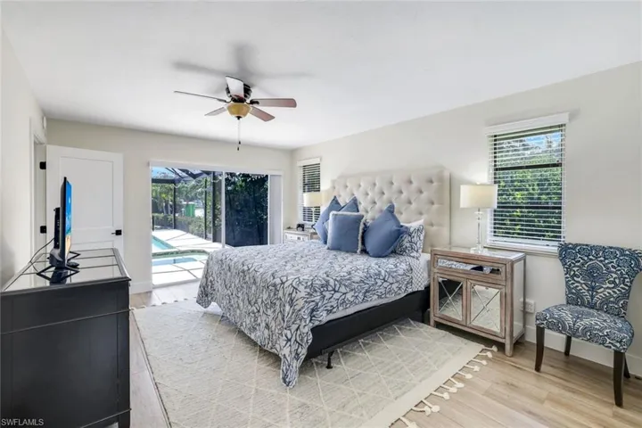 Bedroom featuring light wood-type flooring, access to outside, and a ceiling fan