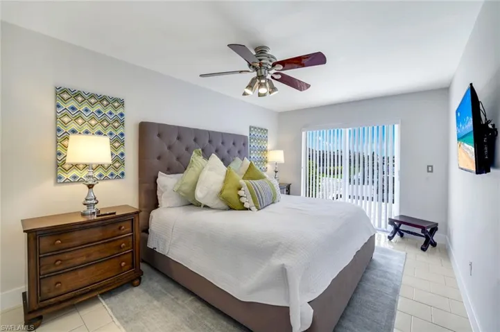 Bedroom featuring ceiling fan, access to outside, and light tile patterned flooring