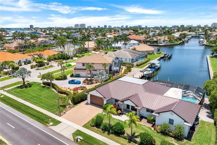Aerial perspective of suburban area with skyline and a large body of water