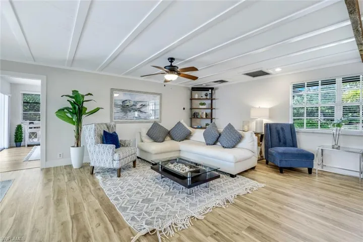 Living room featuring light wood-type flooring and ceiling fan