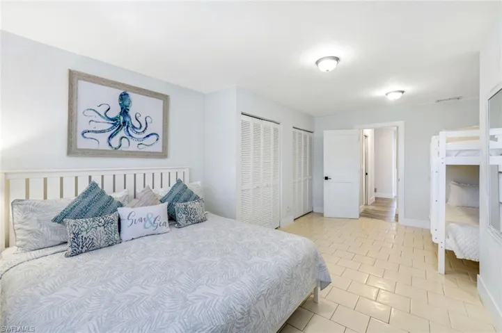 Bedroom featuring multiple closets and light tile patterned flooring