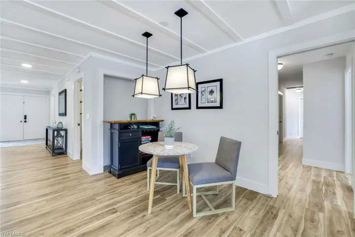 Dining space featuring light wood-style flooring and baseboards