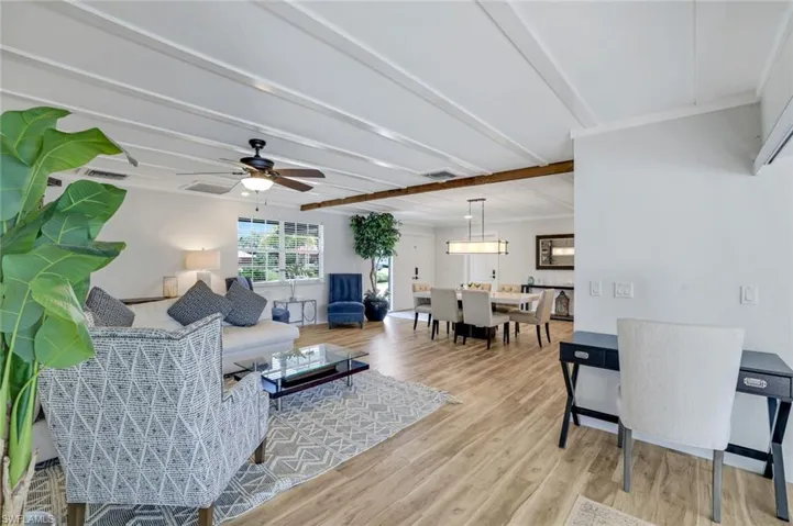 Living room with light wood-type flooring and ceiling fan