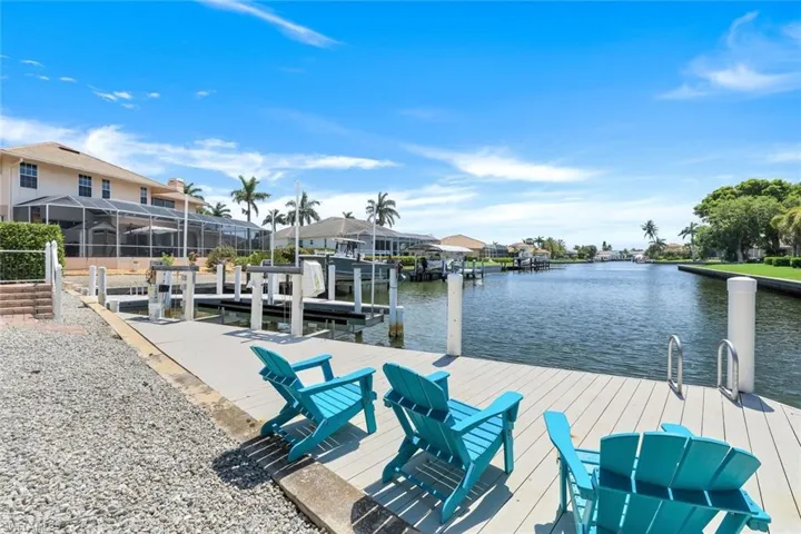 Dock with a water view, a sunroom, and a residential view