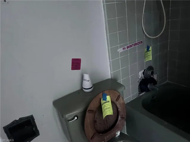 Room details with bathtub / shower combination and toilet