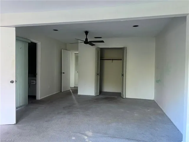 Unfurnished bedroom with carpet, ceiling fan, and a closet