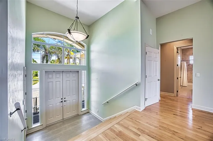 Entryway featuring light wood finished floors and a high ceiling