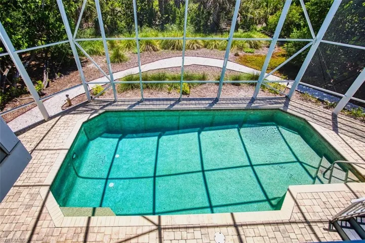 Outdoor pool featuring a lanai and a patio
