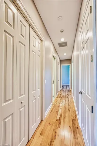 Unfurnished bedroom with light wood finished floors, a closet, and a ceiling fan