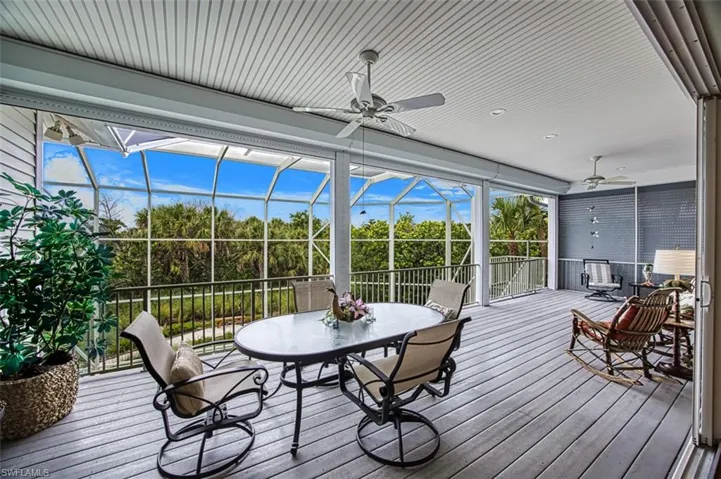 Large lanai with ceiling fan and outdoor dining area