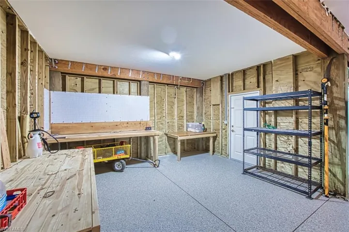 View of below area, epoxy floor, sliders and room for game tables and cars!