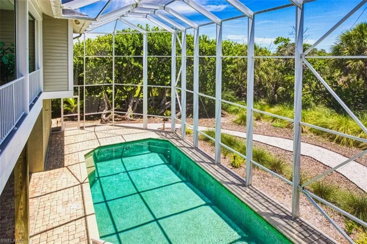 Swimming pool with a lanai and a patio area