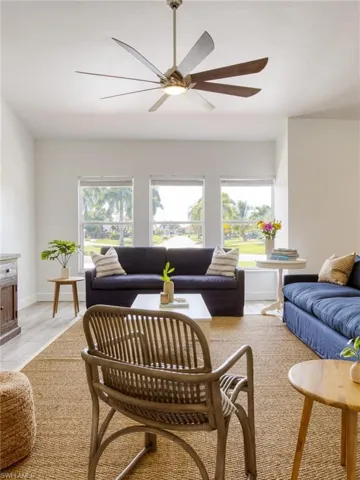 Living area with healthy amount of natural light and ceiling fan