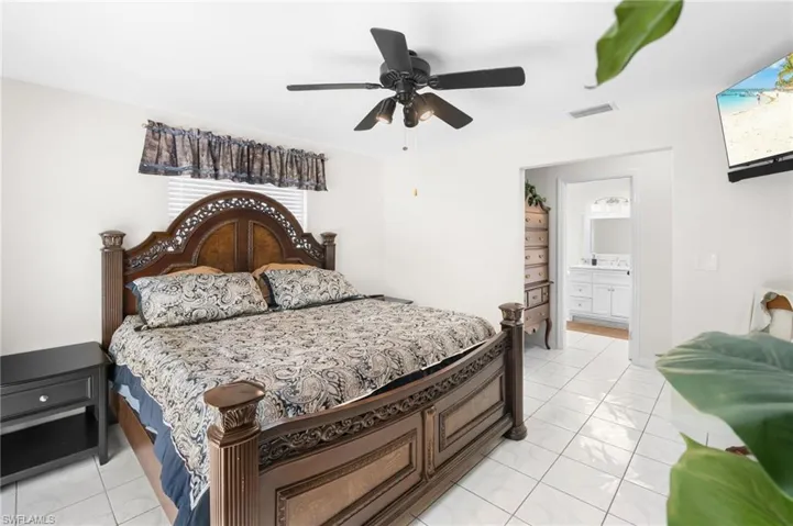 White tile flooring throughout, featuring an overhead ceiling fan