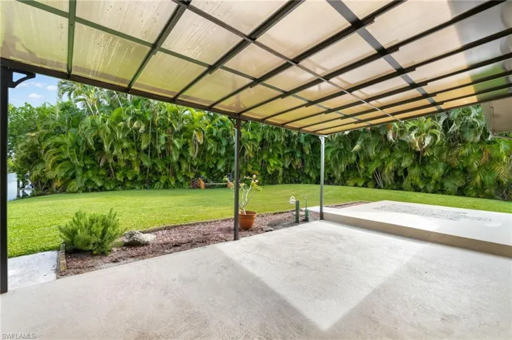 Covered patio featuring concrete flooring and a built-in fire pit