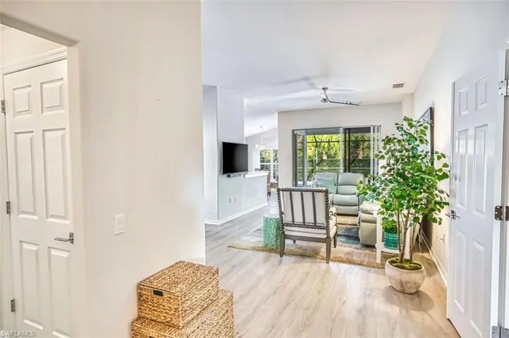 Living area featuring light wood finished floors and a ceiling fan