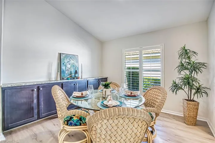 Dining space with light wood finished floors and lofted ceiling