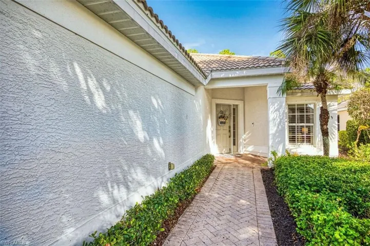 Property entrance featuring stucco siding and a tile roof