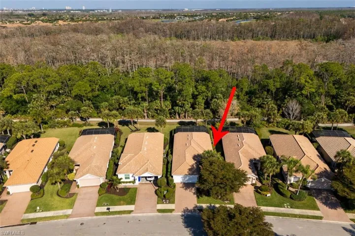 Aerial view of residential area featuring a forest