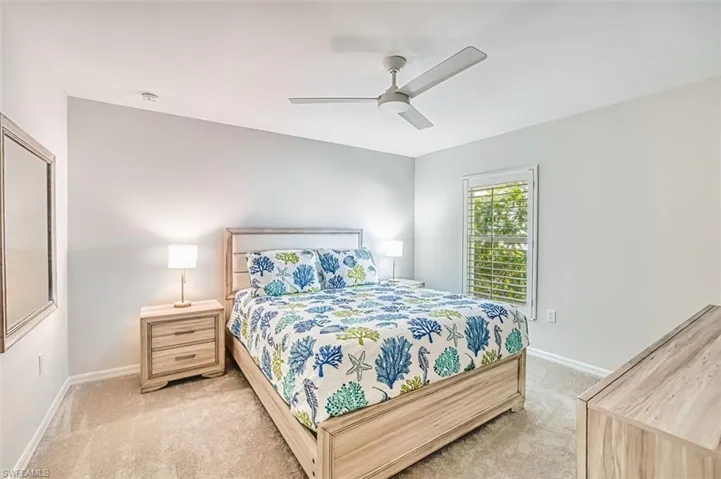 Bedroom featuring ceiling fan and carpet