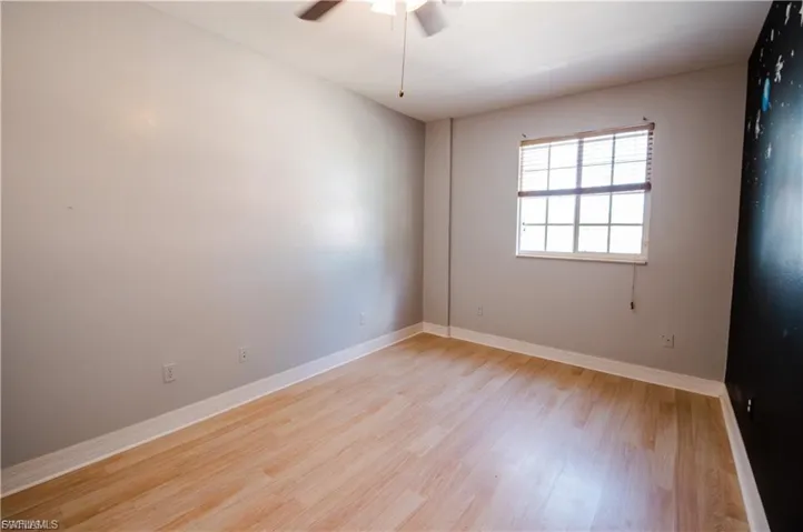 Unfurnished room with light wood-style floors and a ceiling fan