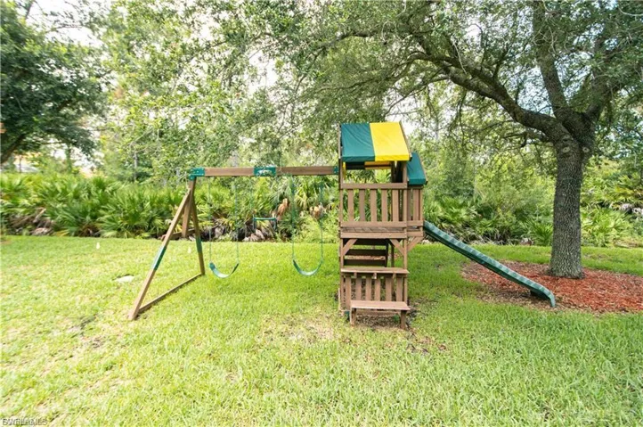 View of playground with a lawn