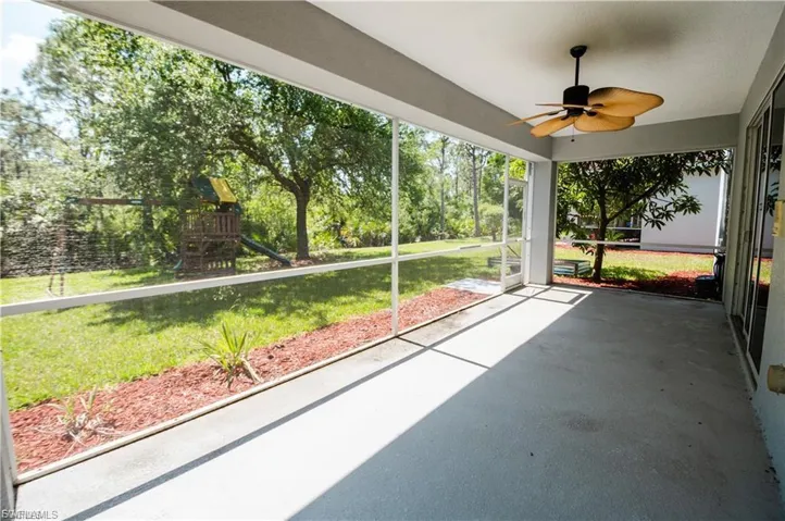 Unfurnished sunroom featuring a ceiling fan
