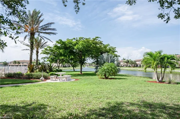 View of yard with a patio area and a water view