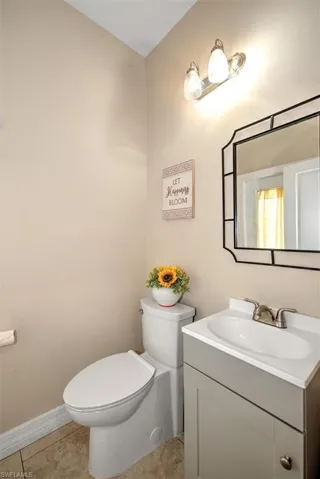 Bathroom with tile patterned flooring, vanity, and toilet