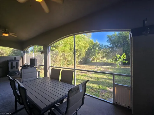 Sunroom featuring ceiling fan and vaulted ceiling