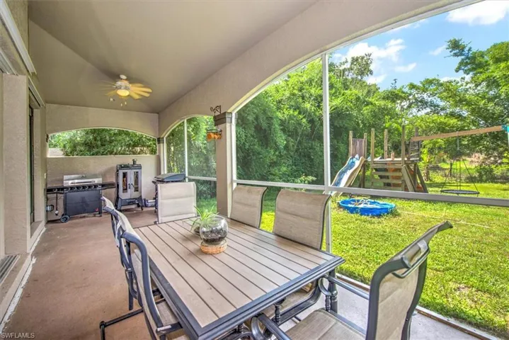 View of patio / terrace featuring a playground and ceiling fan