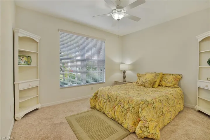 Bedroom with light colored carpet and ceiling fan